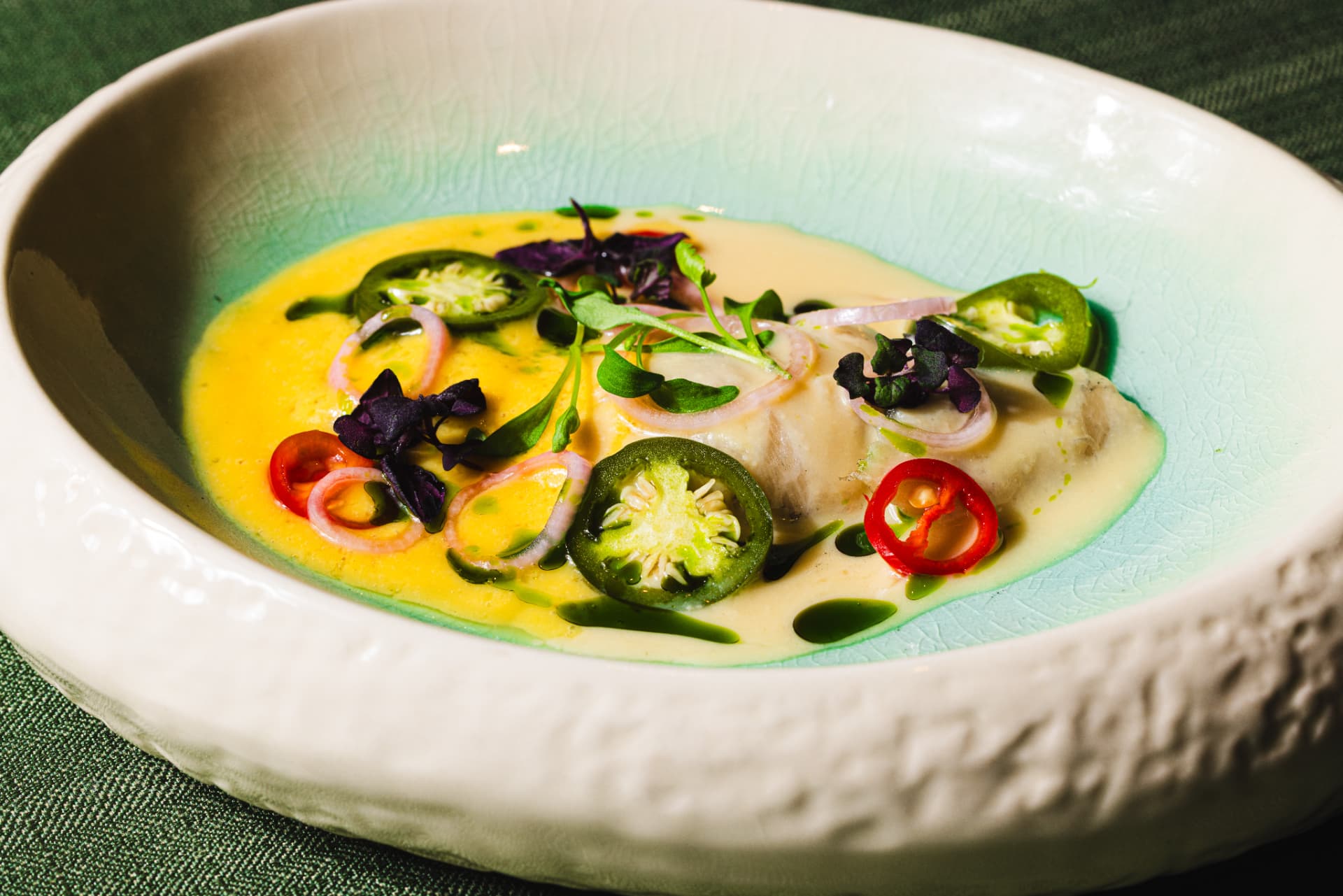 Sea bass in citrus butter with jalapeño and micro herbs at The Margin