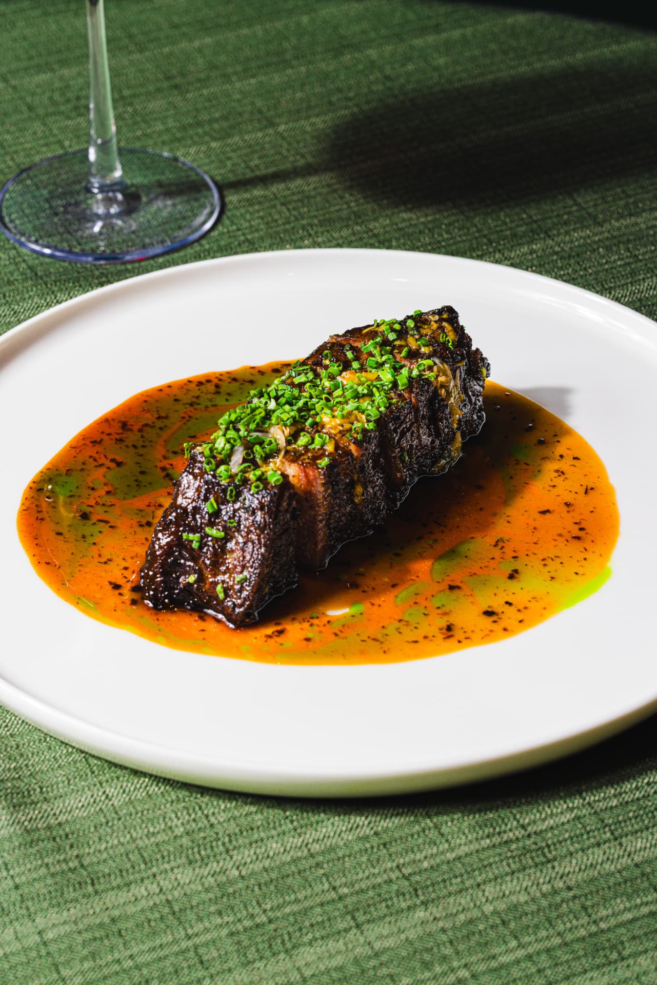 Beef short rib plated with chive garnish at The Margin