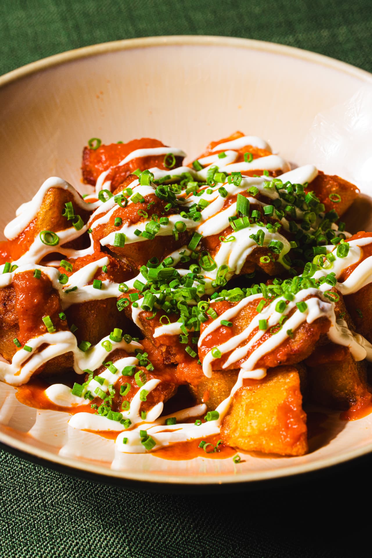 Crisp patatas bravas with spiced tomato sauce, aioli and chives at The Margin